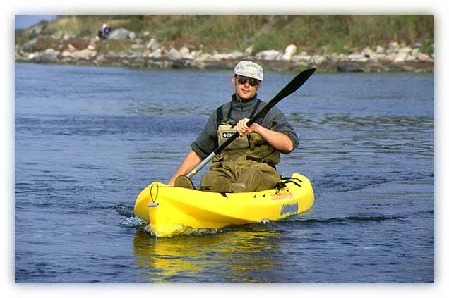 Short trips - The kayak is ideal for moving quickly from place to place while wade fishing.<br />Here I am crossing a narrow gap to an island where no one usually fishes. I do not need a great amount of gear, just my rod tucked down between my legs and my chest pack. For these short trips in warm water I ususally do not bring a life vest either.